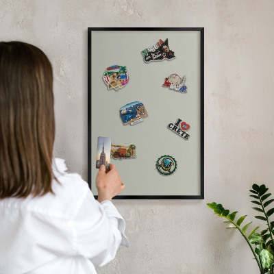 Metal wall board for magnets in a black frame Warm gray