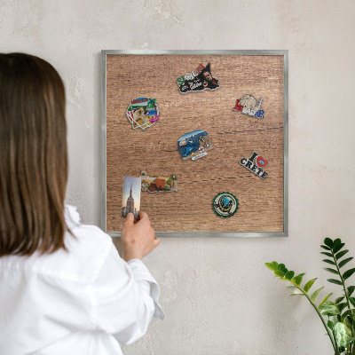 Souvenir magnet display board with a silver frame Wood texture