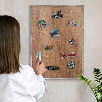 Souvenir magnet display board with a silver frame Wood texture