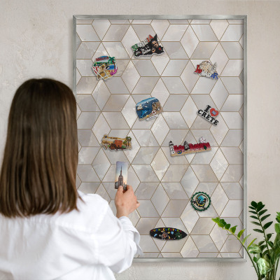 Souvenir magnet display board with a silver frame Cubic background