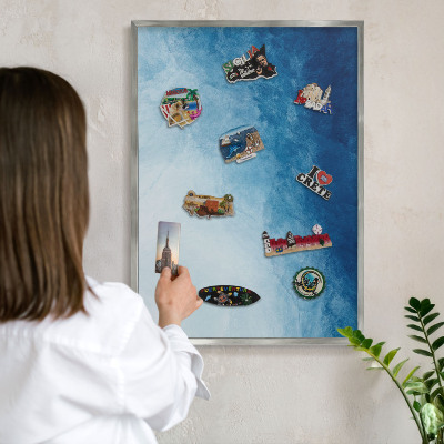 Souvenir magnet display board with a silver frame Blue abstractions