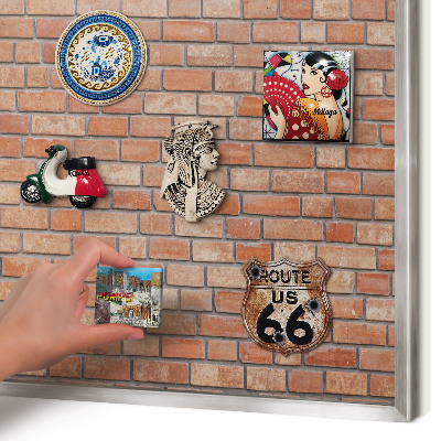 Souvenir magnet display board with a silver frame Brick wall