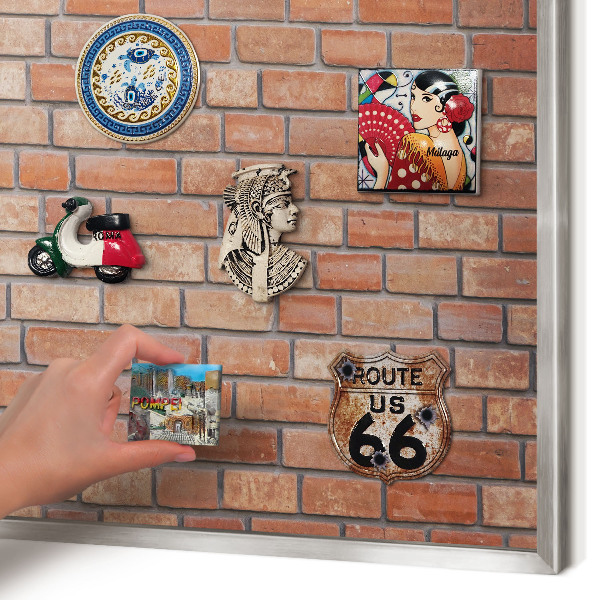 Souvenir magnet display board with a silver frame Brick wall