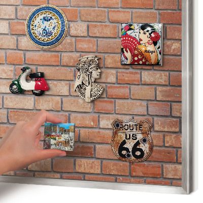 Souvenir magnet display board with a silver frame Brick wall