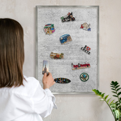 Souvenir magnet display board with a silver frame Gray texture