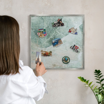 Souvenir magnet display board with a silver frame Green textures