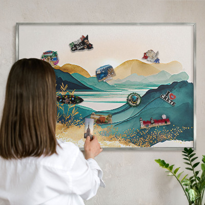 Souvenir magnet display board with a silver frame A peaceful view
