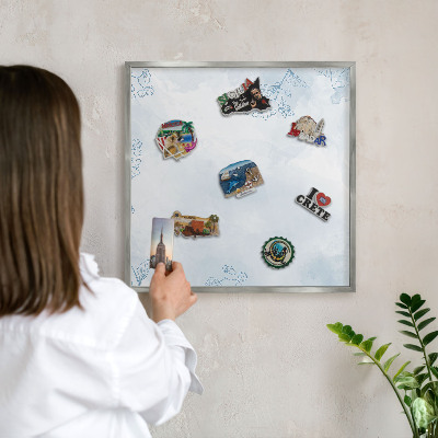 Souvenir magnet display board with a silver frame Floristic elegance