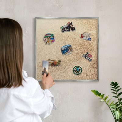 Souvenir magnet display board with a silver frame Sand leaves
