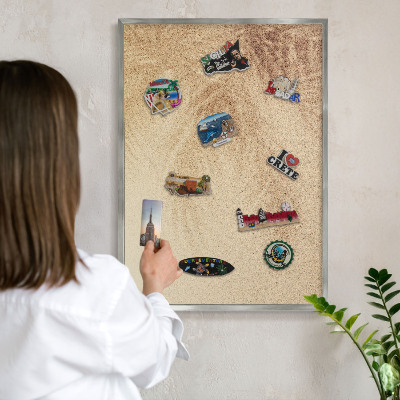 Souvenir magnet display board with a silver frame Sand leaves