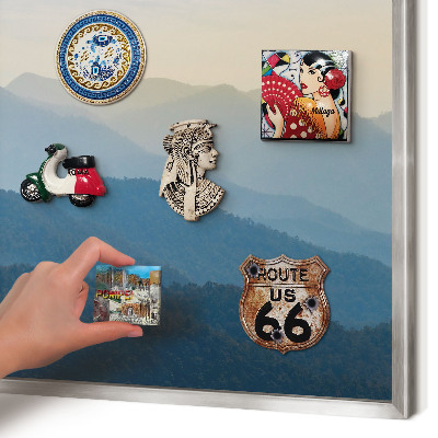 Souvenir magnet display board with a silver frame Mountain views