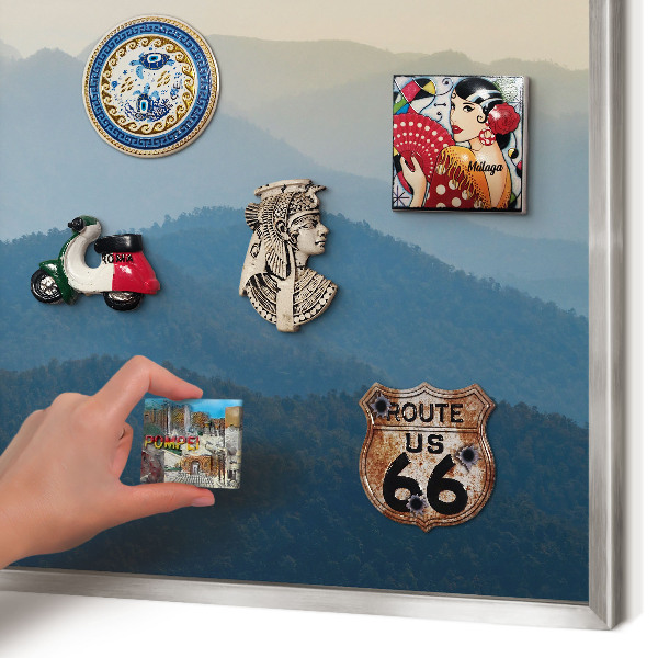 Souvenir magnet display board with a silver frame Mountain views