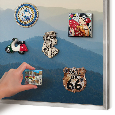 Souvenir magnet display board with a silver frame Mountain views