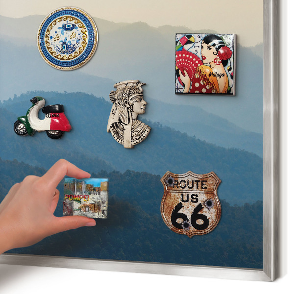 Souvenir magnet display board with a silver frame Mountain views