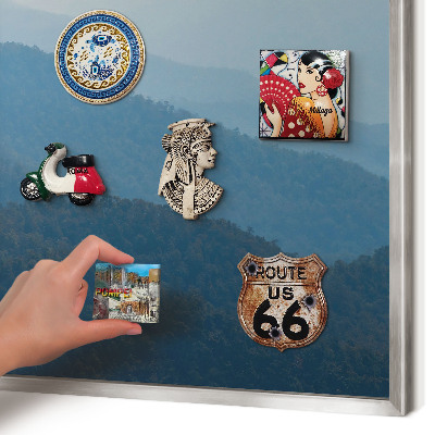 Souvenir magnet display board with a silver frame Mountain views