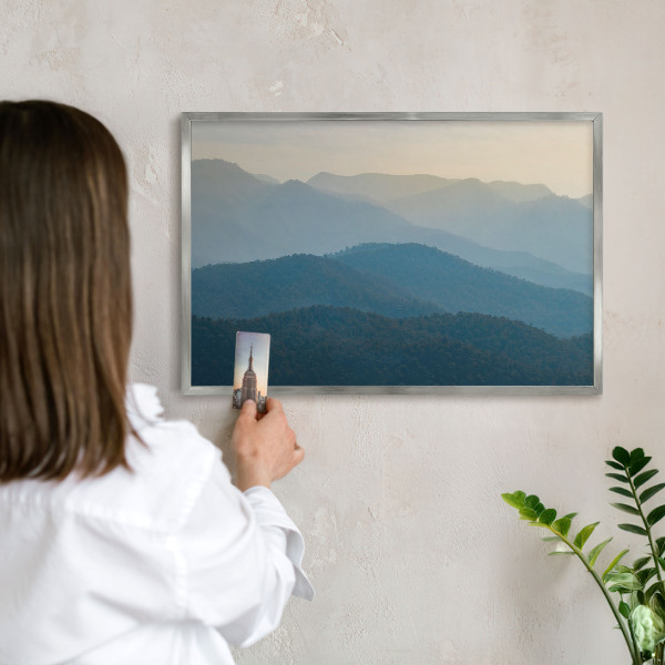 Souvenir magnet display board with a silver frame Mountain views