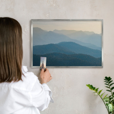 Souvenir magnet display board with a silver frame Mountain views