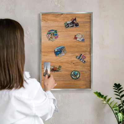Souvenir magnet display board with a silver frame Wooden texture