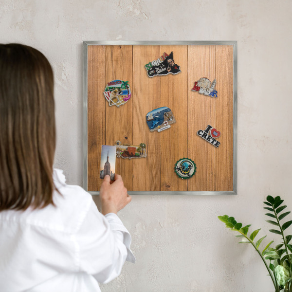 Souvenir magnet display board with a silver frame Wooden texture