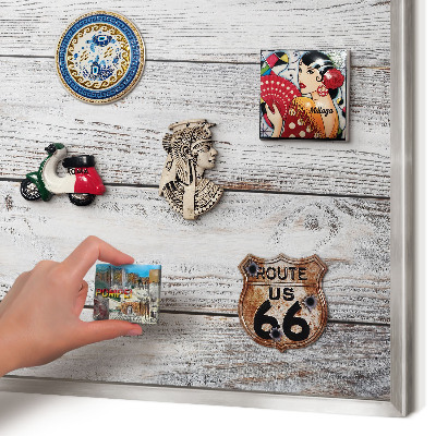 Souvenir magnet display board with a silver frame Rustic wood