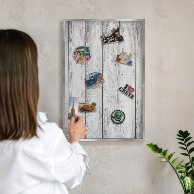 Souvenir magnet display board with a silver frame Rustic wood