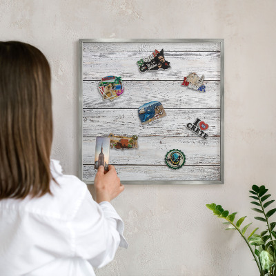 Souvenir magnet display board with a silver frame Rustic wood