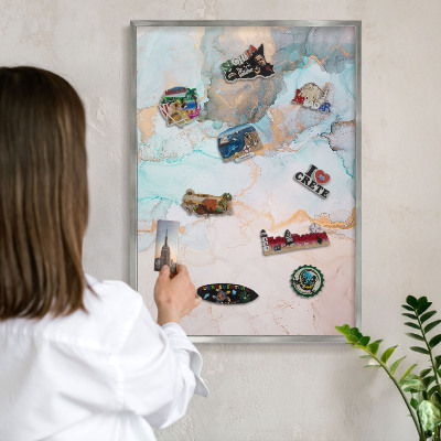 Souvenir magnet display board with a silver frame Pastel forms