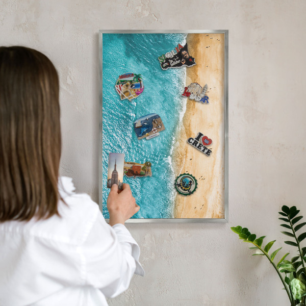 Souvenir magnet display board with a silver frame Sea and beach