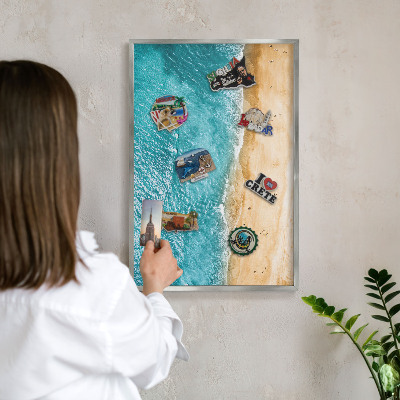 Souvenir magnet display board with a silver frame Sea and beach