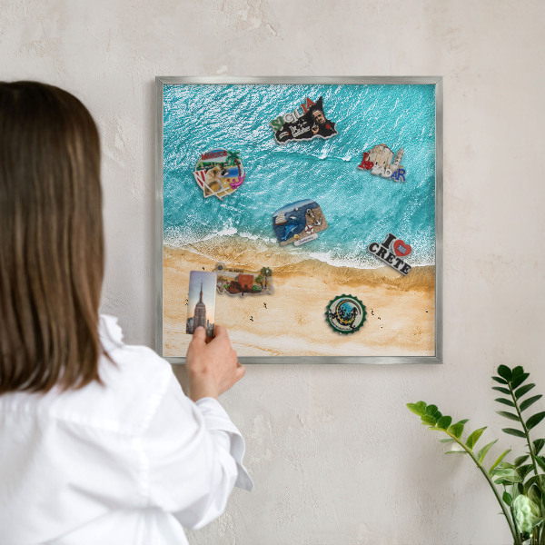 Souvenir magnet display board with a silver frame Sea and beach