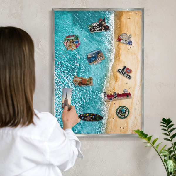 Souvenir magnet display board with a silver frame Sea and beach