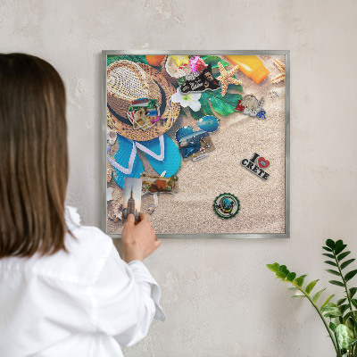 Souvenir magnet display board with a silver frame Summer relaxation