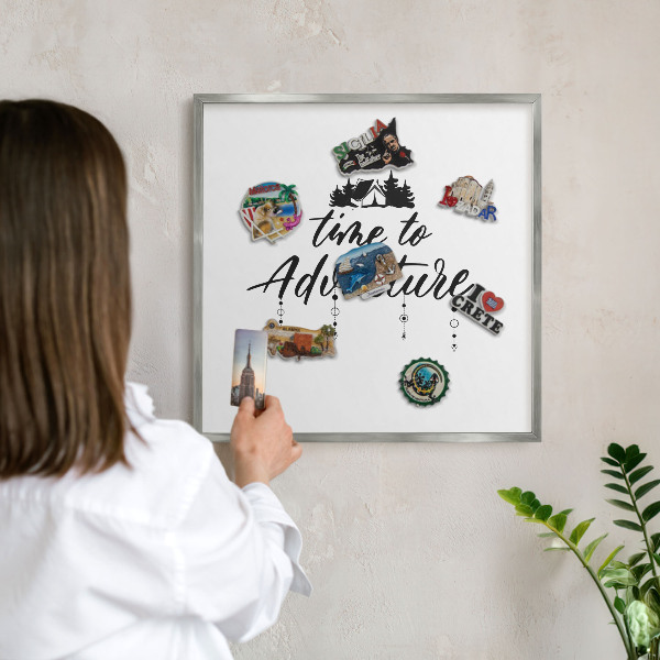 Souvenir magnet display board with a silver frame Adventure awaits