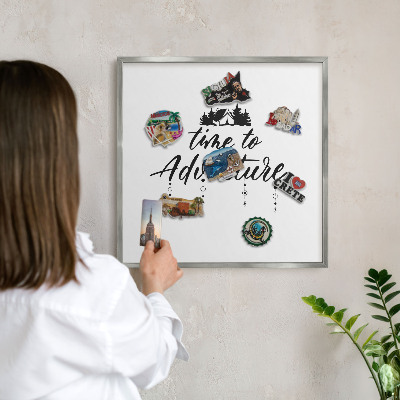 Souvenir magnet display board with a silver frame Adventure awaits
