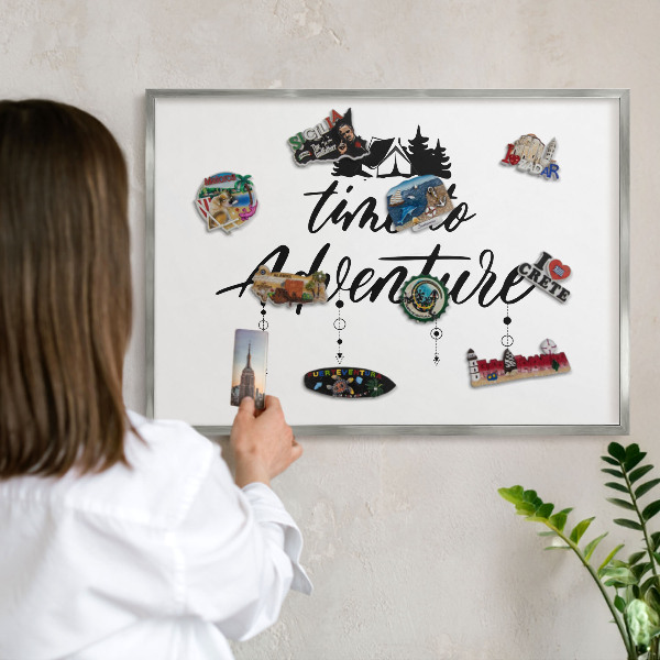 Souvenir magnet display board with a silver frame Adventure awaits