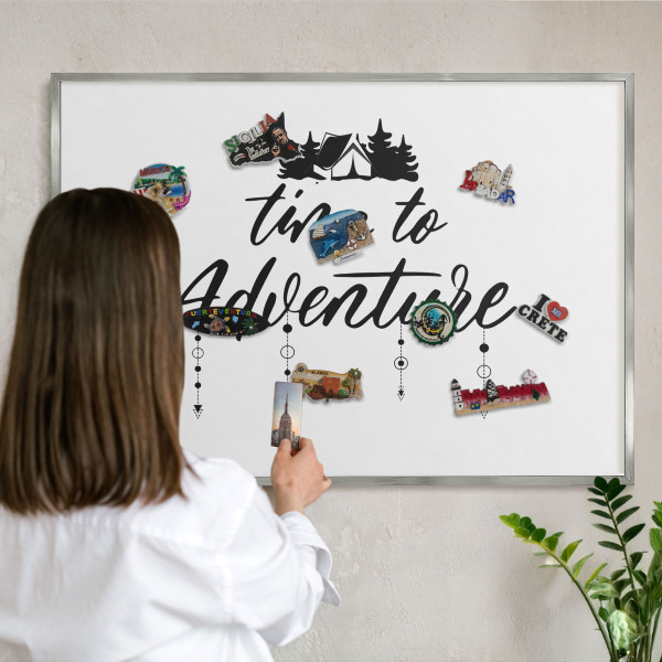 Souvenir magnet display board with a silver frame Adventure awaits
