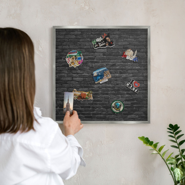Souvenir magnet display board with a silver frame Brick wall