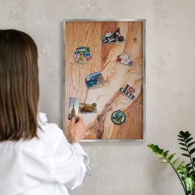 Souvenir magnet display board with a silver frame Wooden texture