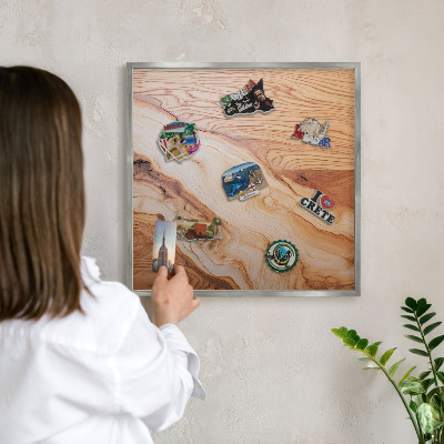 Souvenir magnet display board with a silver frame Wooden texture