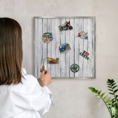Souvenir magnet display board with a silver frame Light wood