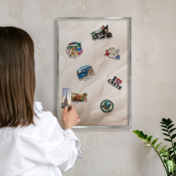 Souvenir magnet display board with a silver frame Cream feathers