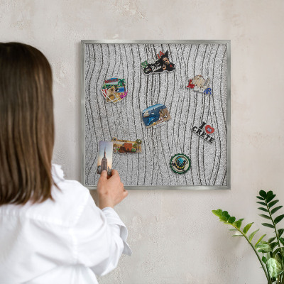 Souvenir magnet display board with a silver frame Gray waves