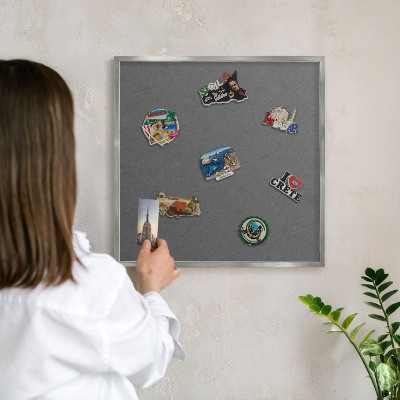 Souvenir magnet display board with a silver frame Gray texture