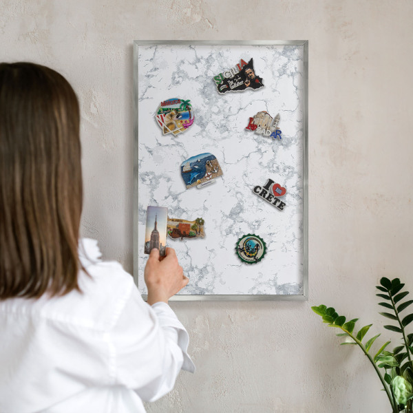 Souvenir magnet display board with a silver frame Marble aesthetics
