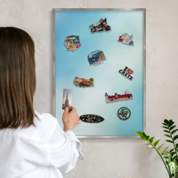 Souvenir magnet display board with a silver frame Blue sky