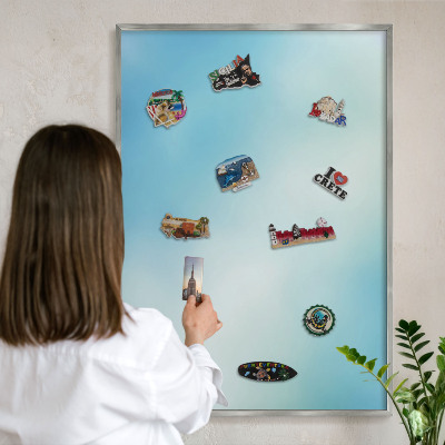 Souvenir magnet display board with a silver frame Blue sky
