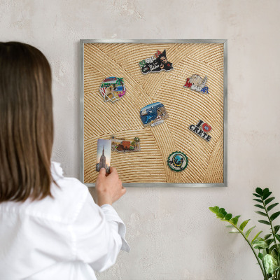 Souvenir magnet display board with a silver frame Structural lines