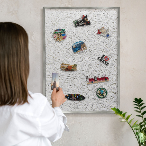 Souvenir magnet display board with a silver frame Openwork elegance