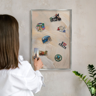 Souvenir magnet display board with a silver frame Elegant abstraction