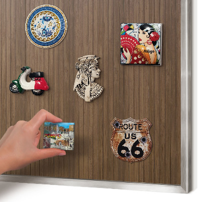 Souvenir magnet display board with a silver frame Wooden background